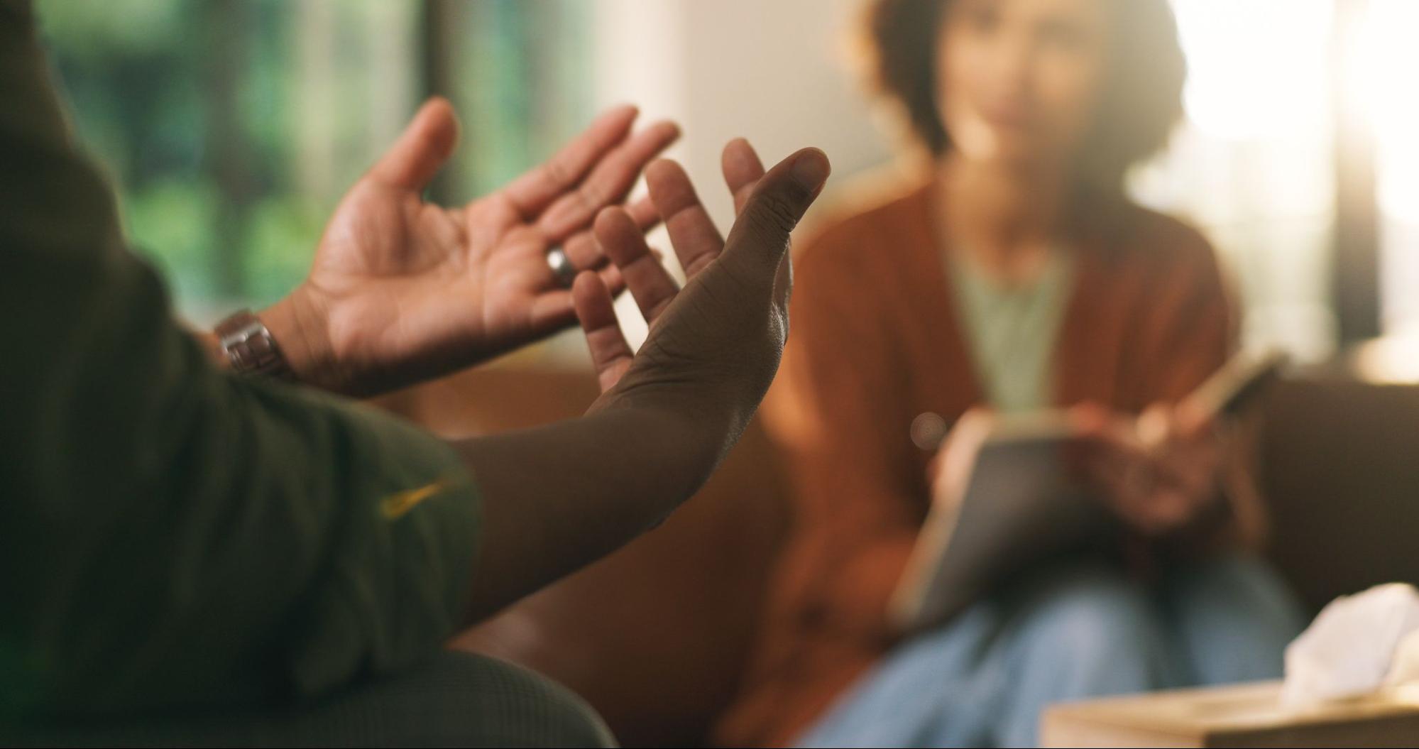 Therapist and adult client talking in a bright office during an outpatient therapy session in Massachusetts